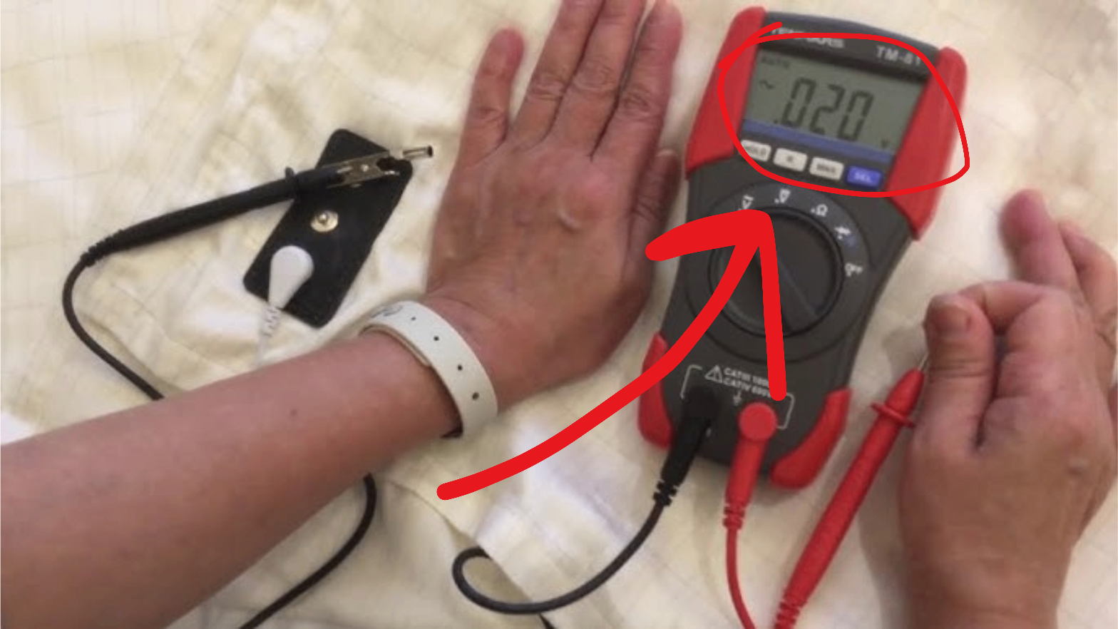Multimeter testing showing 0.20 volts
